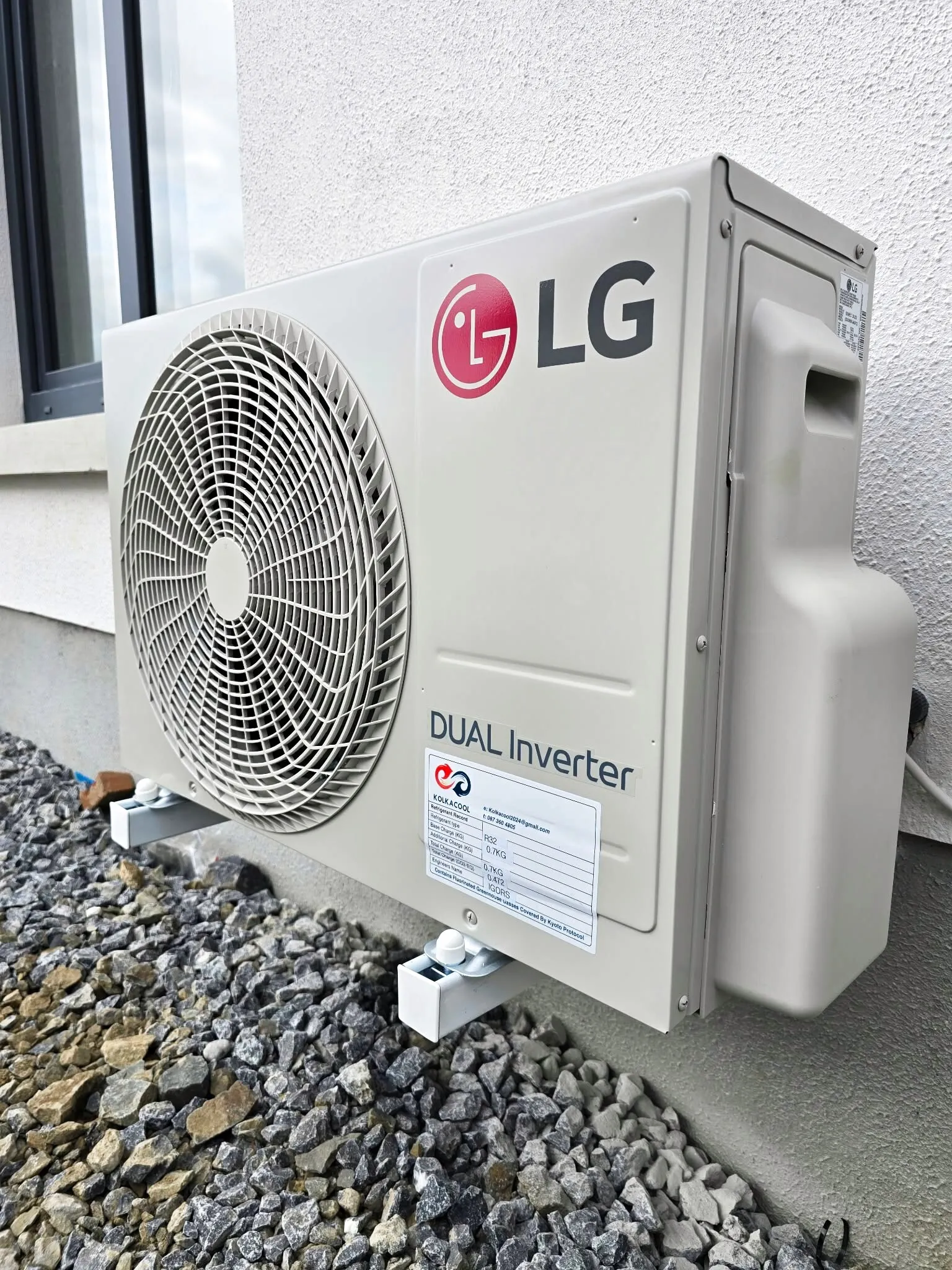 LG Dual Inverter outdoor unit on a gravel base
