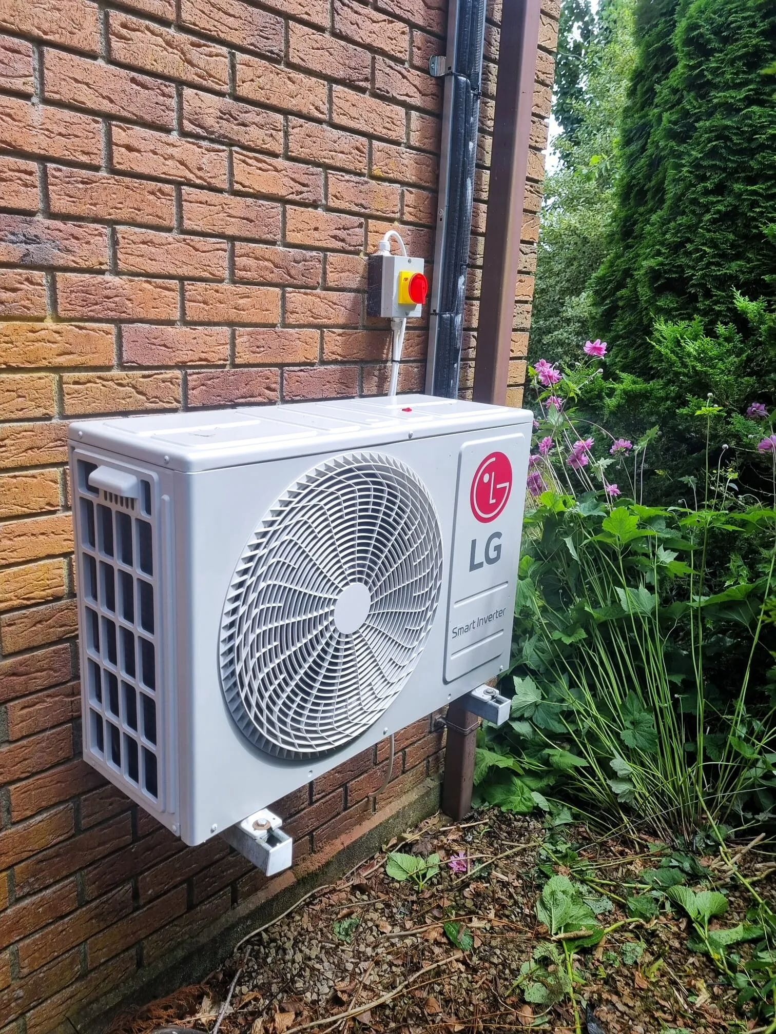LG outdoor unit mounted on a brick wall