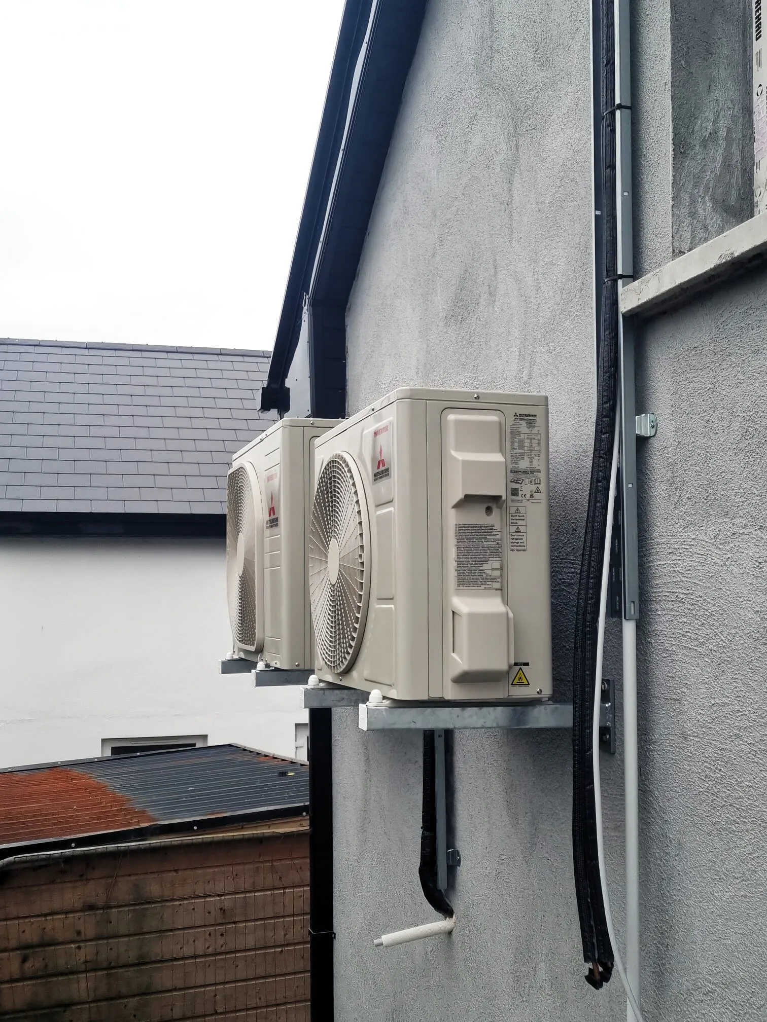 Mitsubishi outdoor units on wall brackets