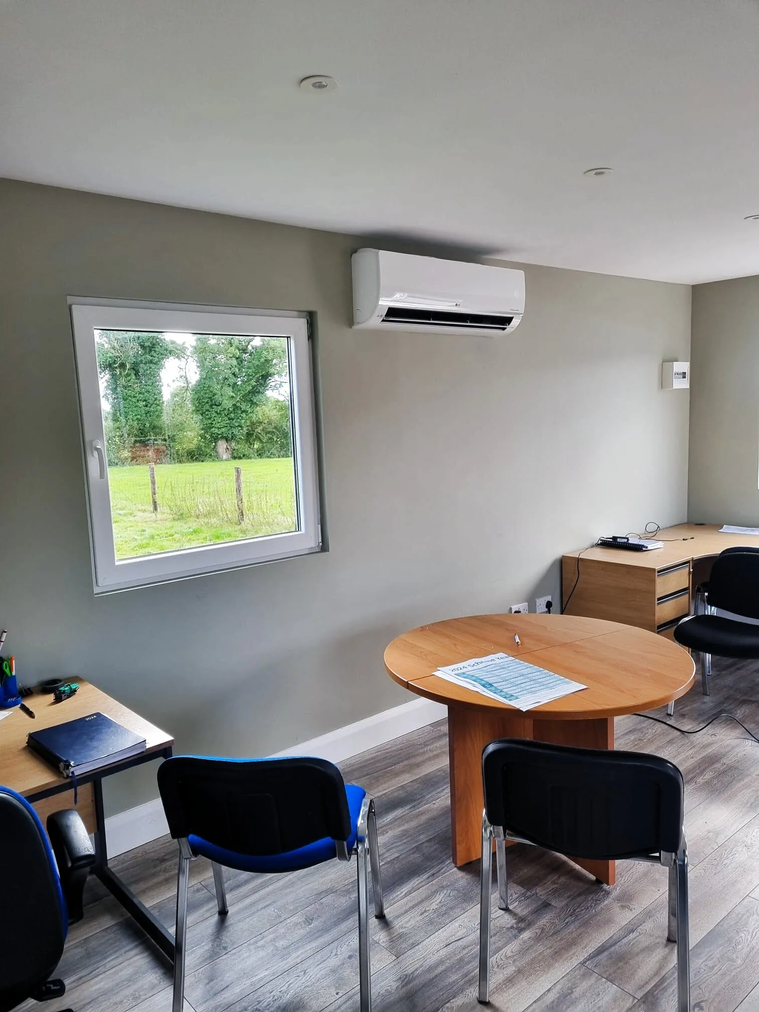 Wall-mounted air conditioner in a small office meeting room