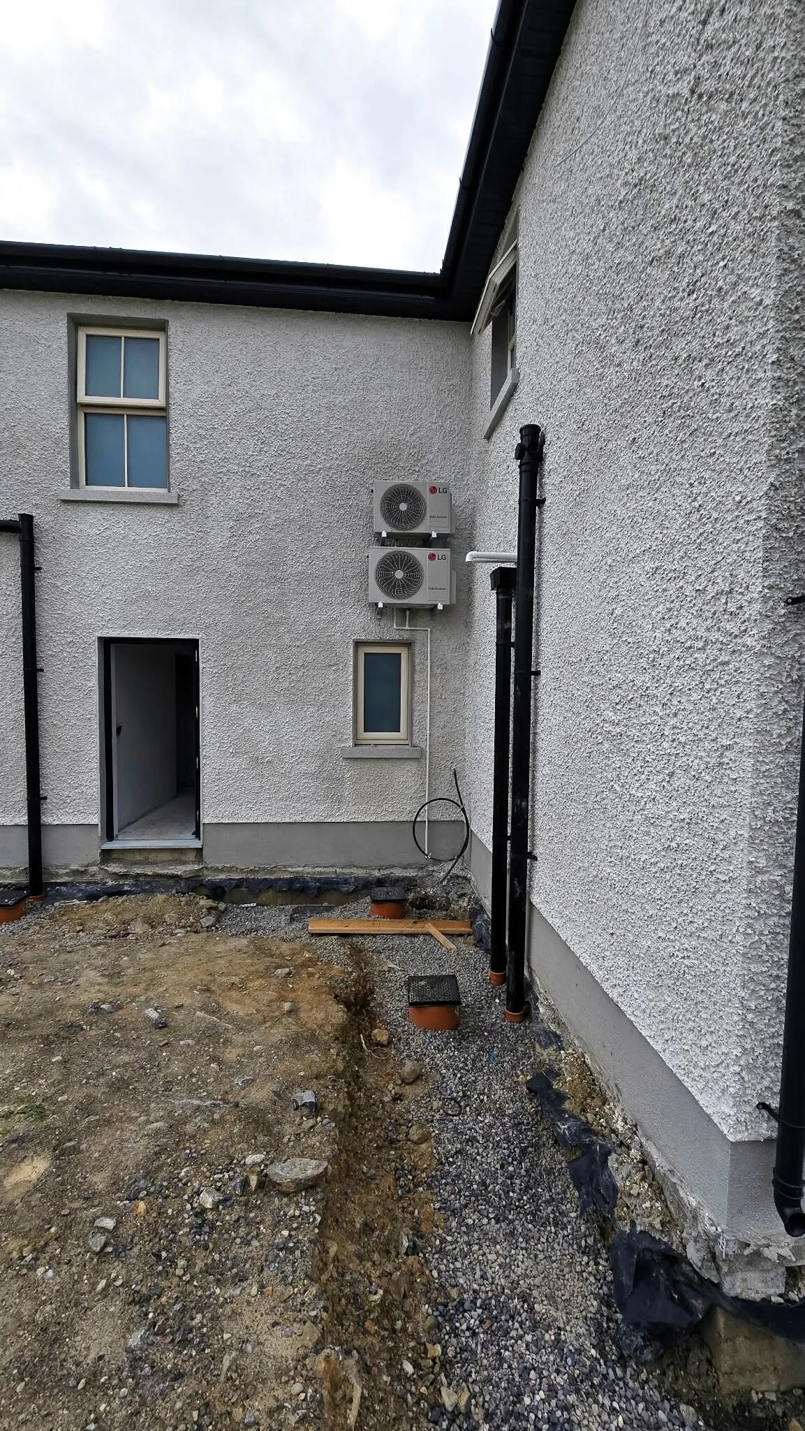 Outdoor units mounted on the side wall of a house
