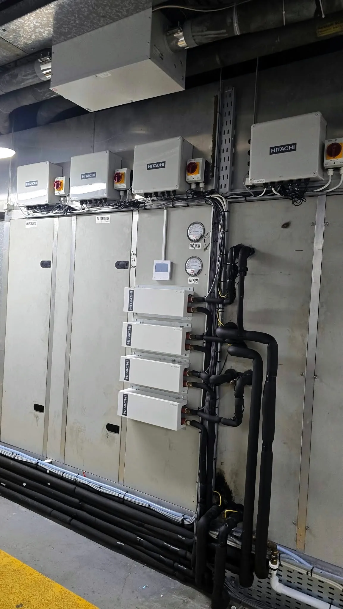 VRF branch boxes and insulated pipework in a plant area