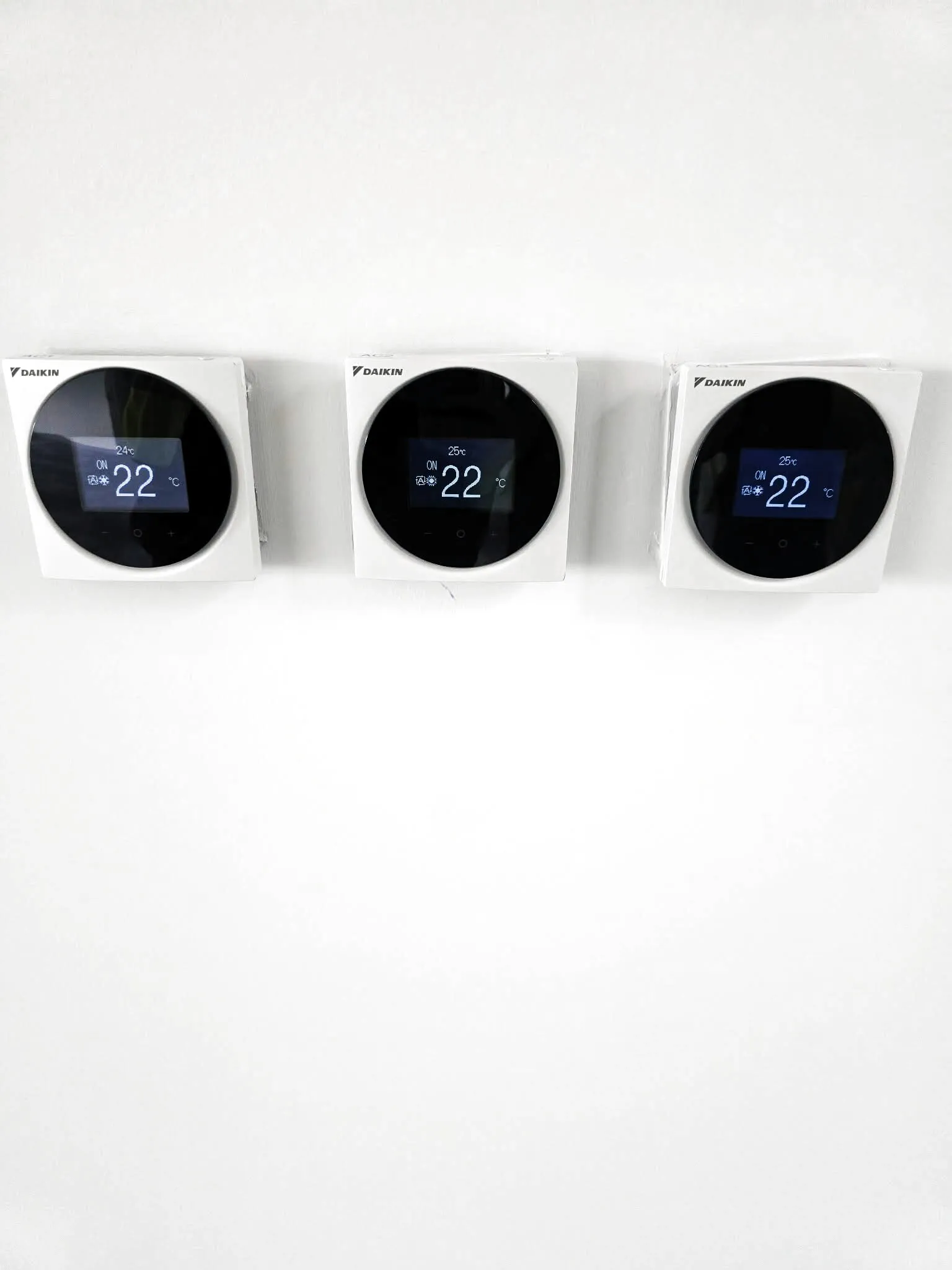 Three wall-mounted air conditioning controllers